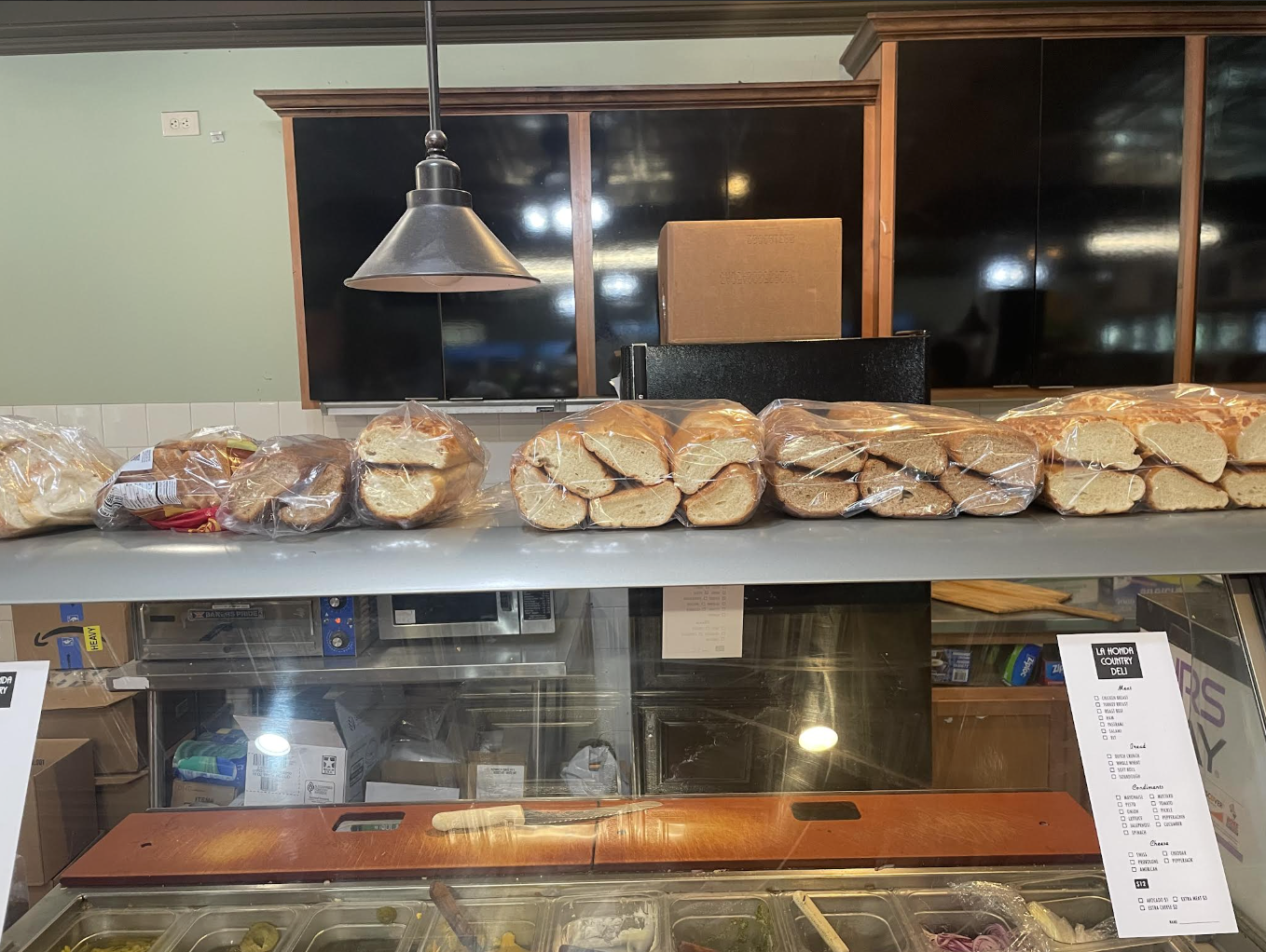 Fresh bagels lined up above the deli counter